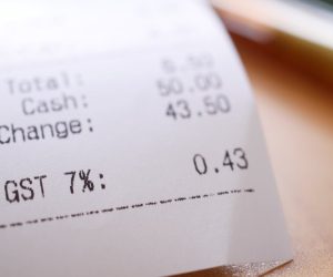 Detailed close-up image of a shopping receipt showing GST and total changes.